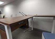 L-Shaped adjustable desk with plug