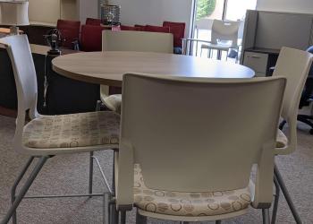 Breakroom table with grey chairs