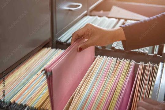Vertical filing cabinets holding files